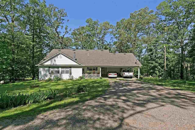 ranch-style home with a front yard and a carport