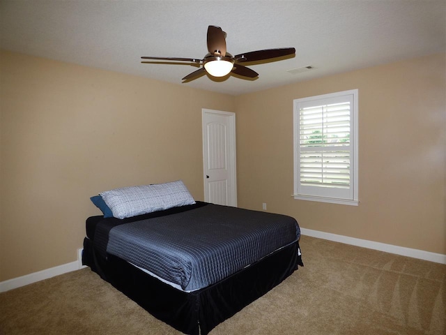 carpeted bedroom featuring ceiling fan