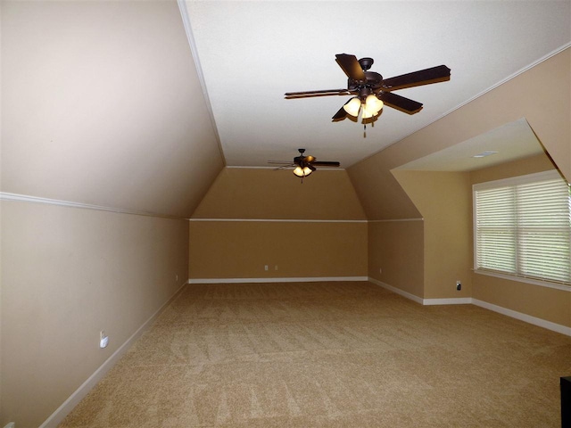 additional living space with lofted ceiling, light colored carpet, and ceiling fan