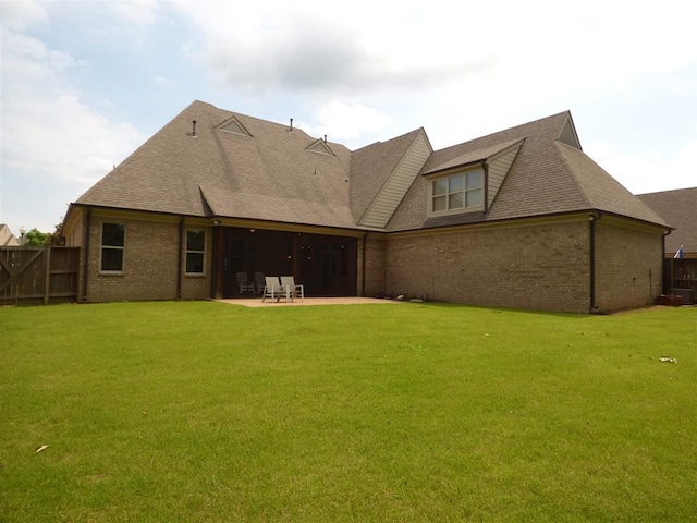 rear view of property featuring central AC unit, a patio area, and a yard