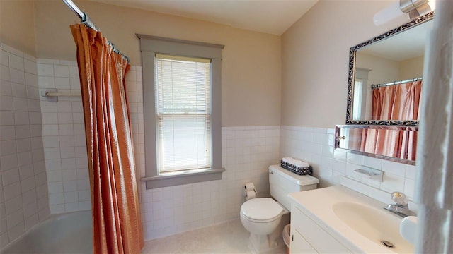 full bathroom with shower / bath combo with shower curtain, tile walls, toilet, and a wealth of natural light