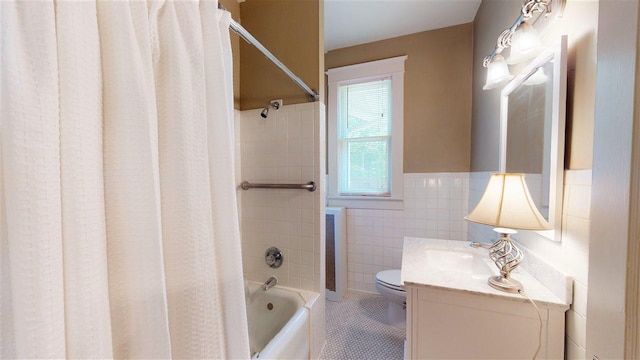 full bathroom featuring vanity, toilet, tile walls, and shower / bathtub combination with curtain