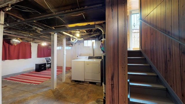 basement with independent washer and dryer and wood walls