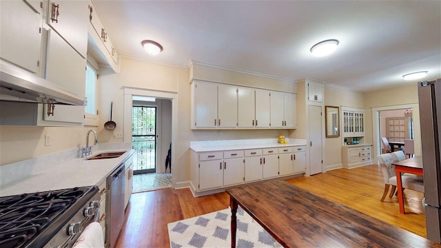 kitchen featuring white cabinets, sink, dishwasher, and light wood-type flooring