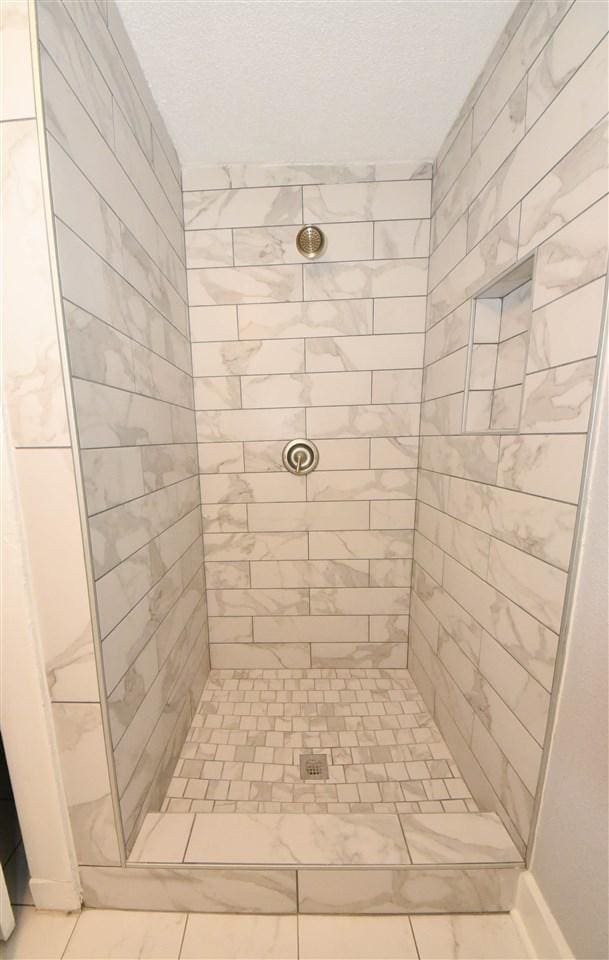 bathroom with a tile shower