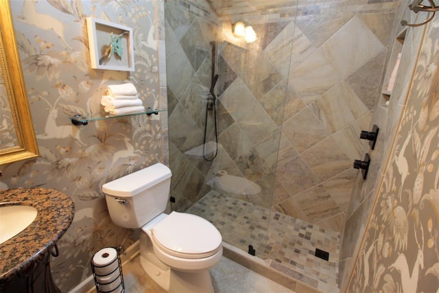 9351 Rocky Valley Cv, Memphis, TN 38018 - bathroom featuring toilet, vanity, tiled shower, and tile flooring