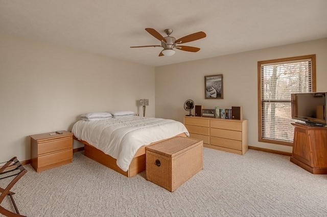 bedroom with ceiling fan and light carpet