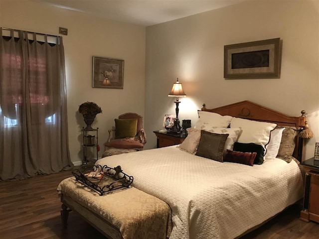 bedroom with dark hardwood / wood-style floors