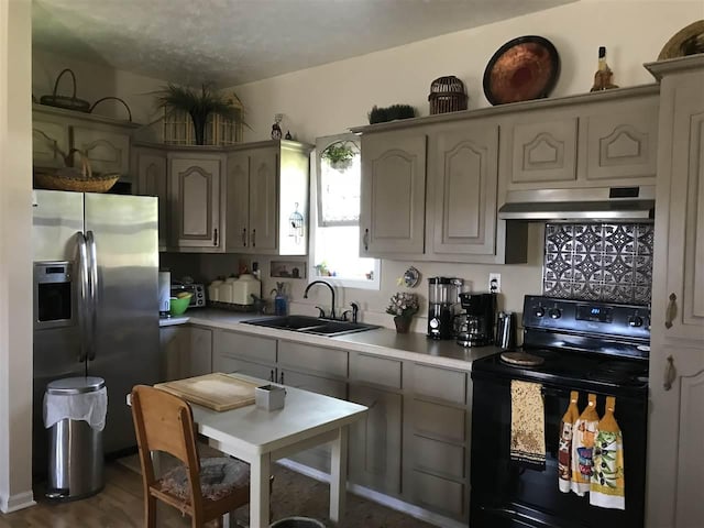 kitchen featuring dark hardwood / wood-style flooring, gray cabinets, black electric range, stainless steel fridge with ice dispenser, and sink