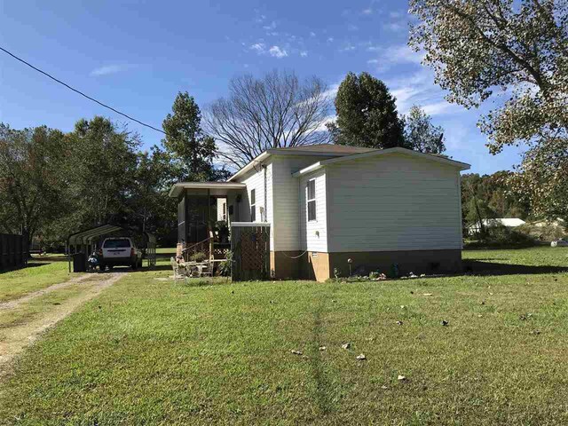 view of home's exterior with a yard