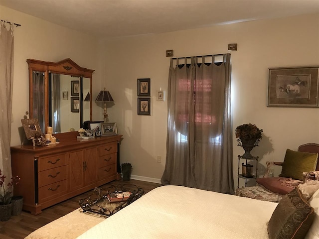 bedroom with dark hardwood / wood-style flooring