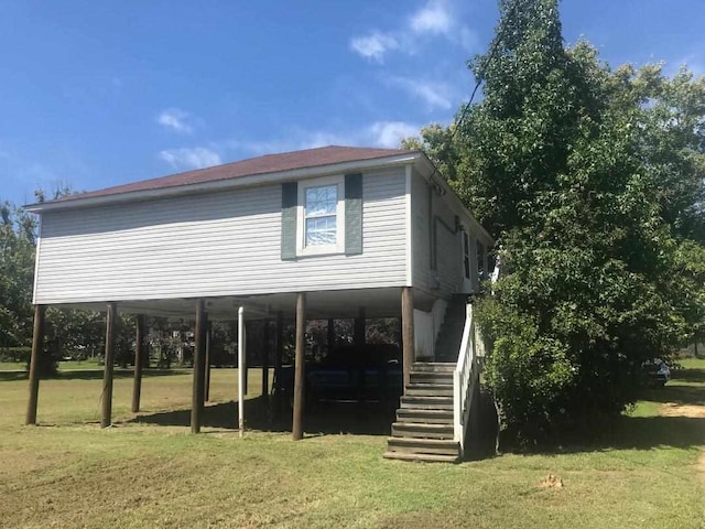 rear view of house featuring a lawn