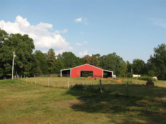 view of yard with a rural view and an outdoor structure