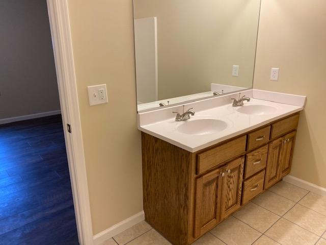 bathroom featuring double sink vanity and hardwood / wood-style flooring