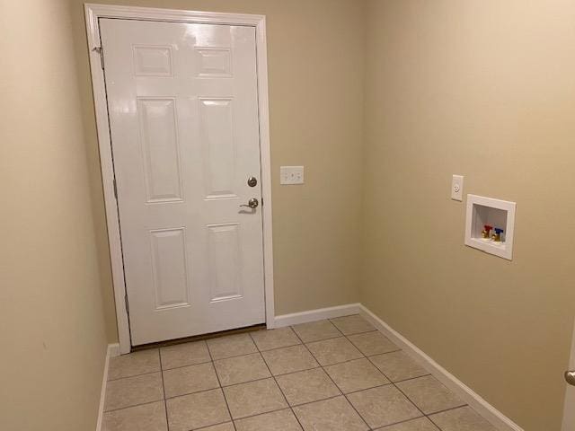 clothes washing area featuring light tile flooring and washer hookup