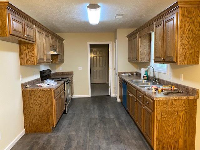 kitchen with stainless steel range with electric stovetop, a textured ceiling, and dark hardwood / wood-style flooring