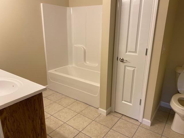 full bathroom featuring tile floors, toilet, vanity, and bathtub / shower combination