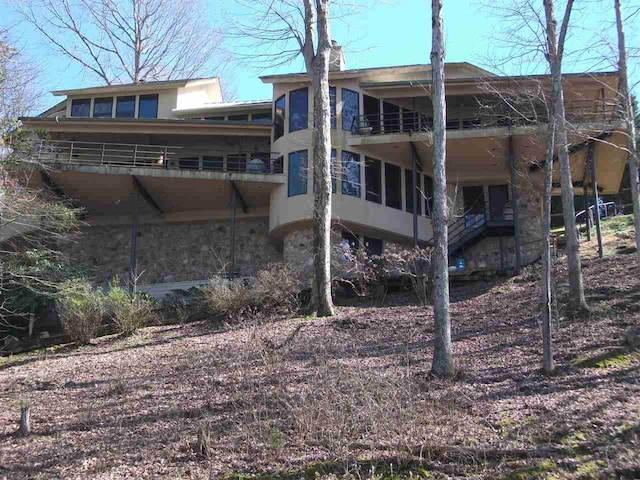 back of property featuring a balcony