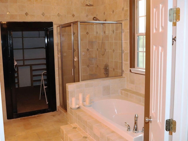 bathroom with tile flooring and separate shower and tub