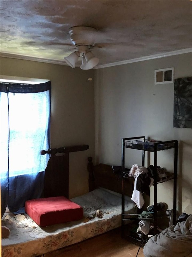 bedroom featuring crown molding, hardwood / wood-style floors, and ceiling fan