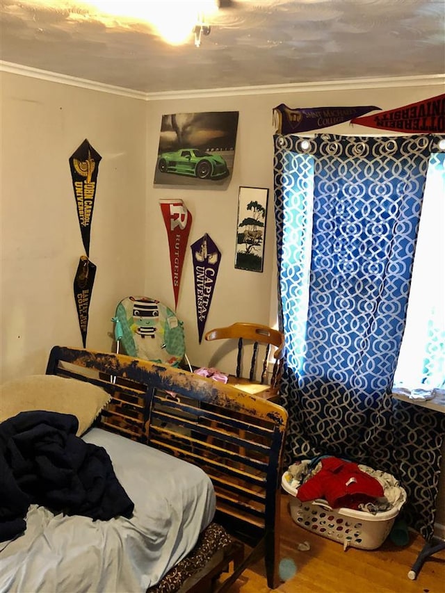 bedroom featuring ornamental molding and hardwood / wood-style floors