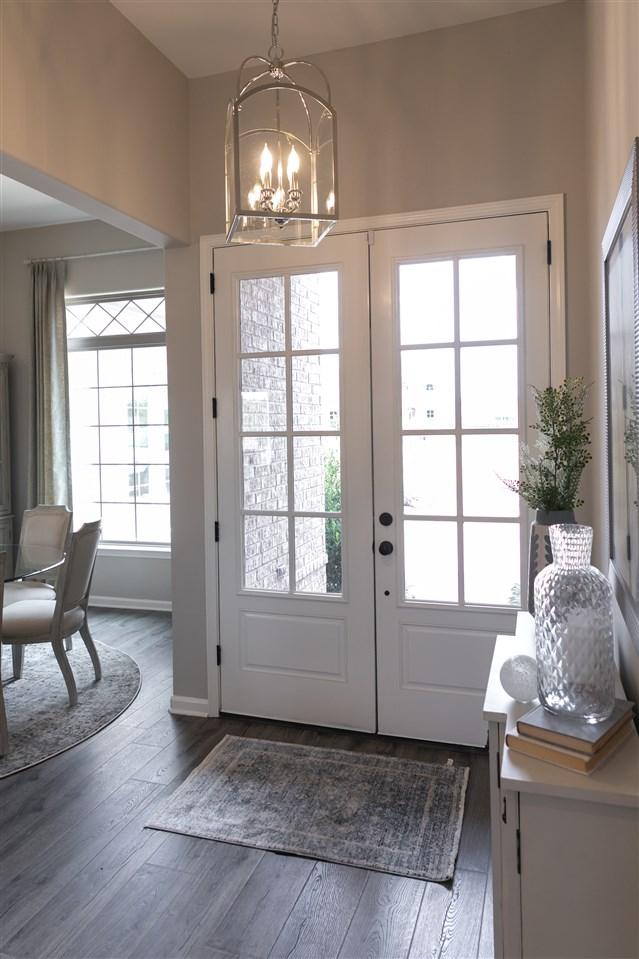 entryway featuring french doors, dark hardwood / wood-style flooring, and a notable chandelier