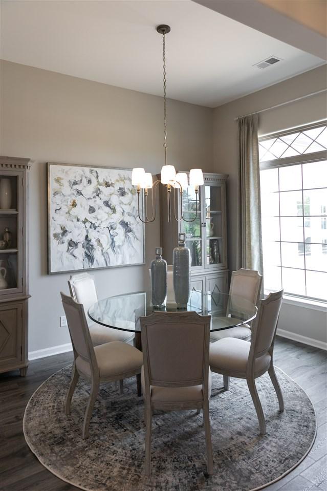 dining space with a notable chandelier and wood-type flooring