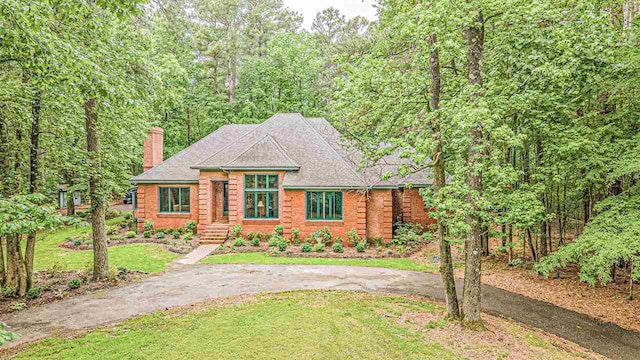 log-style house with a front yard