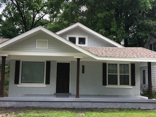 rear view of property with covered porch