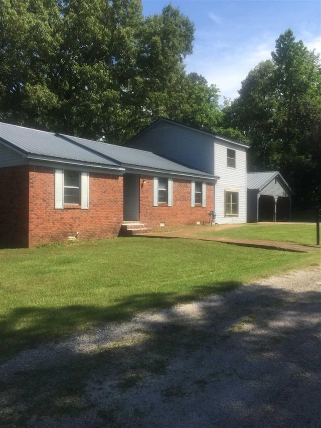 rear view of house with a lawn