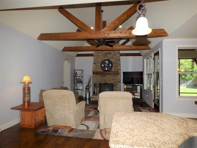 living room with dark hardwood / wood-style flooring, lofted ceiling with beams, and a fireplace