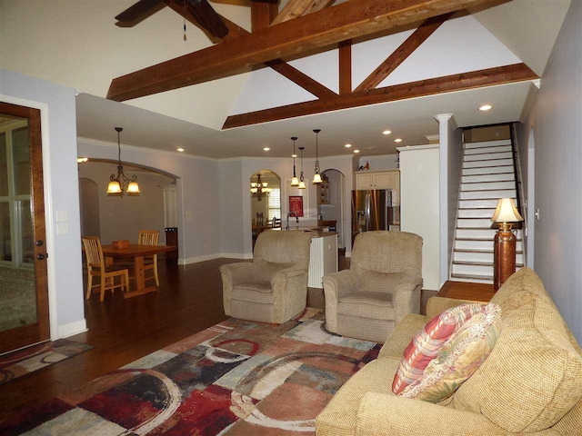 living room featuring ceiling fan with notable chandelier, sink, lofted ceiling with beams, crown molding, and dark hardwood / wood-style flooring