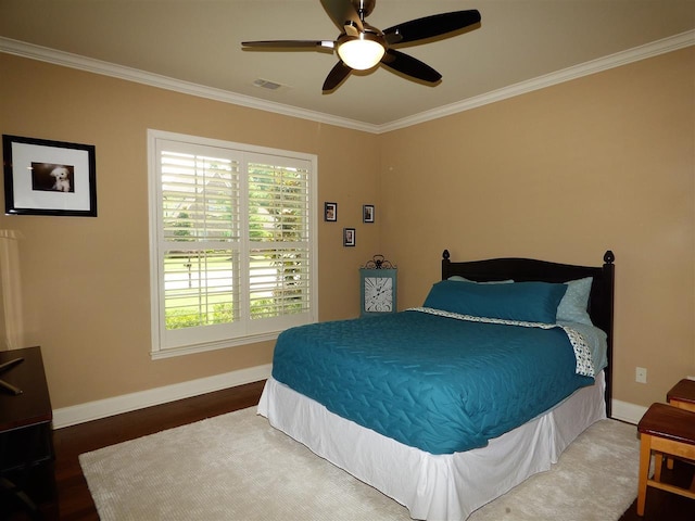 bedroom with ceiling fan, dark wood-type flooring, and ornamental molding