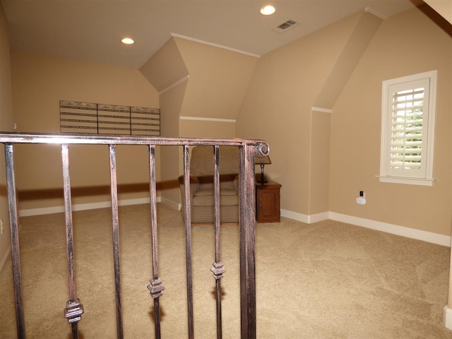 staircase featuring light carpet and vaulted ceiling