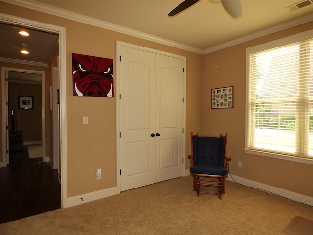 living area with light colored carpet, ceiling fan, and crown molding