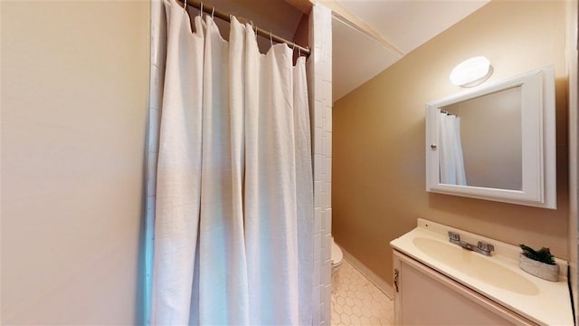 bathroom featuring toilet and vanity