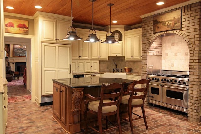 9351 Rocky Valley Cv, Memphis, TN 38018 - kitchen featuring dark stone counters, backsplash, a kitchen island, and double oven range
