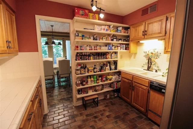 9351 Rocky Valley Cv, Memphis, TN 38018 - kitchen with tile counters, pendant lighting, sink, paneled dishwasher, and backsplash
