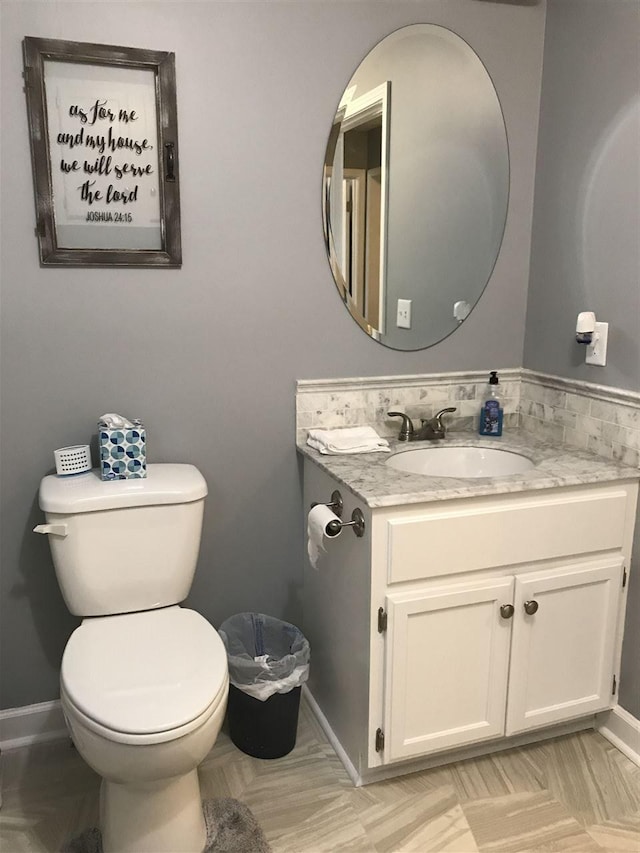 bathroom with toilet and vanity