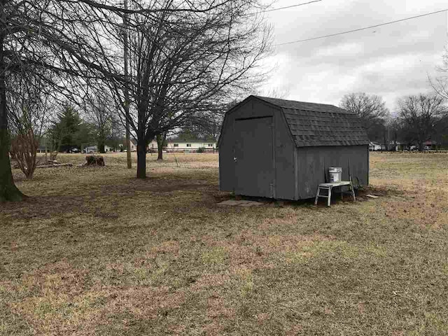 view of outdoor structure featuring a lawn