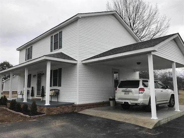 view of front facade with a porch and a carport