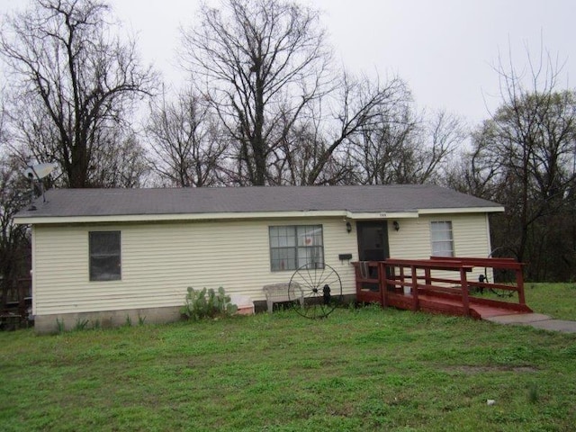 view of front of house with a front yard and a wooden deck