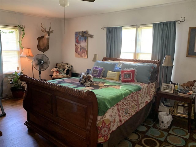 bedroom with ceiling fan and dark wood-type flooring