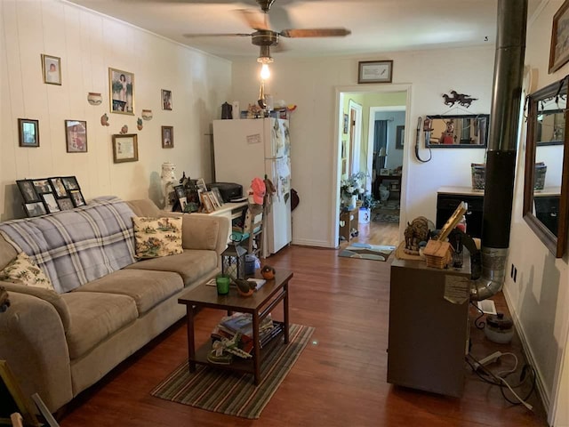 living room featuring ceiling fan and dark wood-type flooring