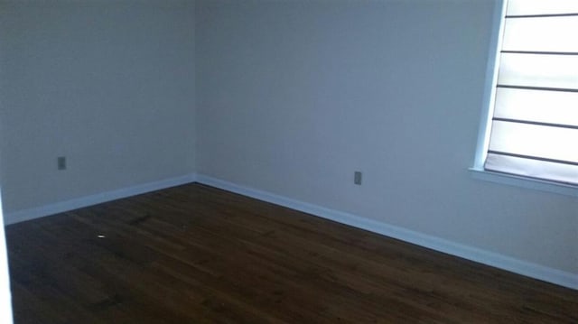 spare room featuring dark hardwood / wood-style flooring