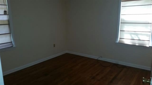 unfurnished room featuring dark hardwood / wood-style floors