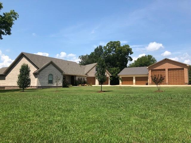 view of front facade with a front yard and a garage