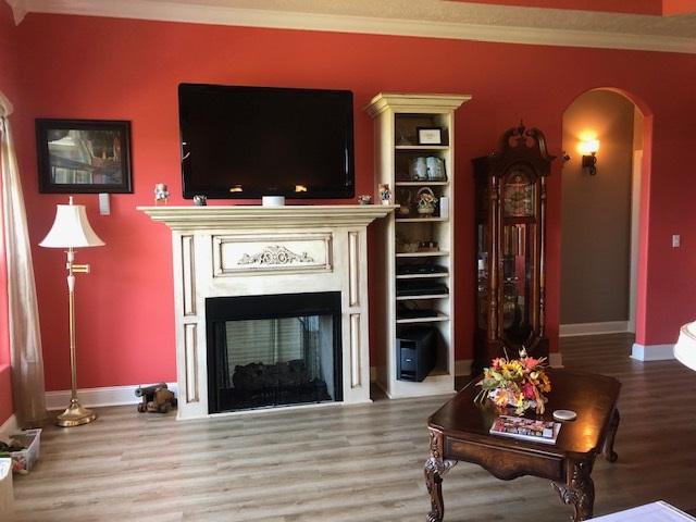 living room featuring crown molding and hardwood / wood-style floors