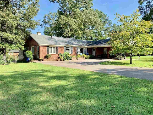 ranch-style home featuring a front yard