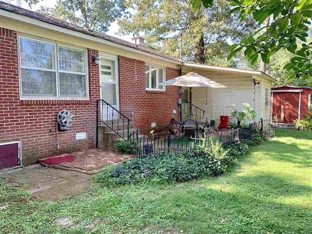 back of property featuring an outdoor structure and a yard